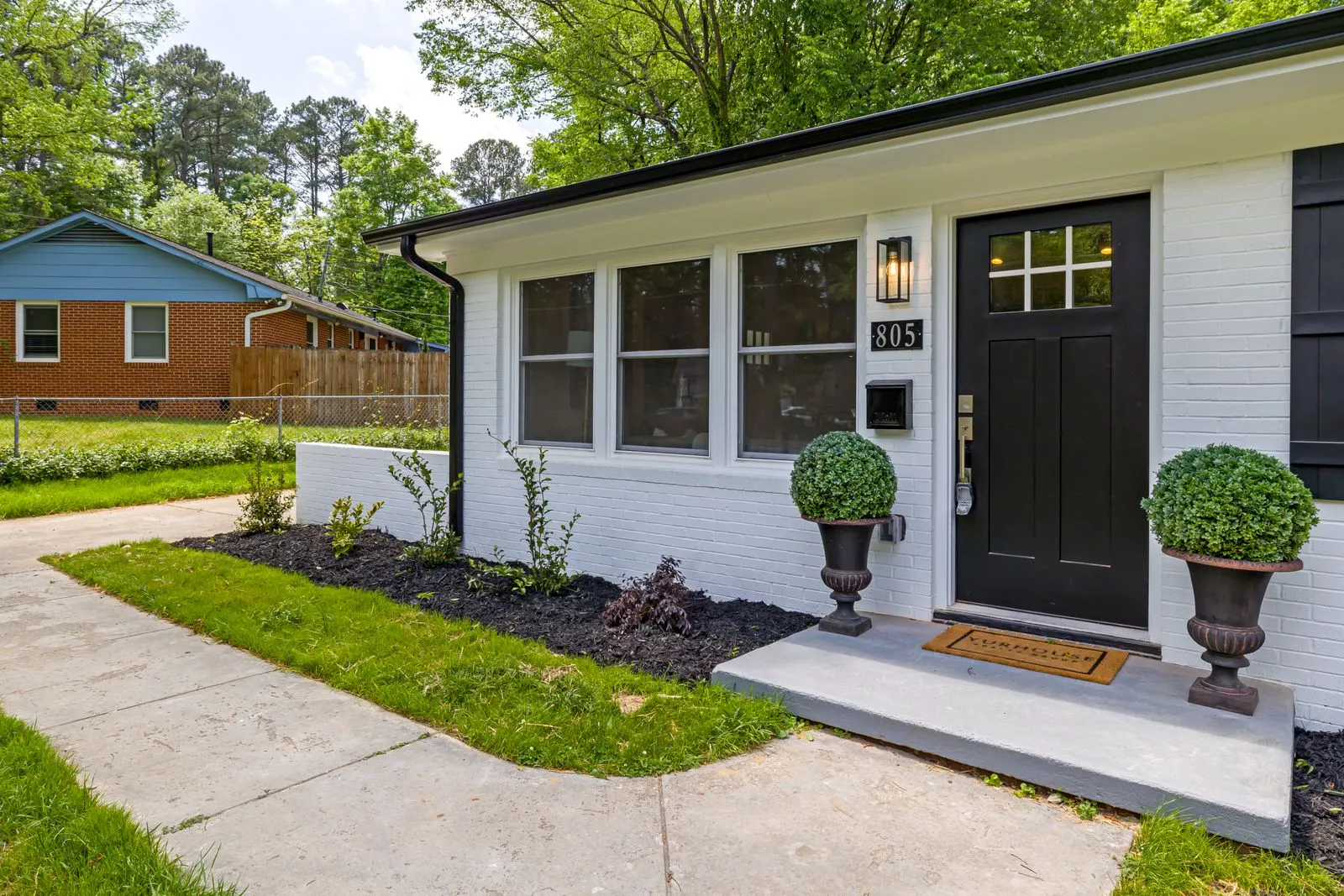 A tidy home with a black front door