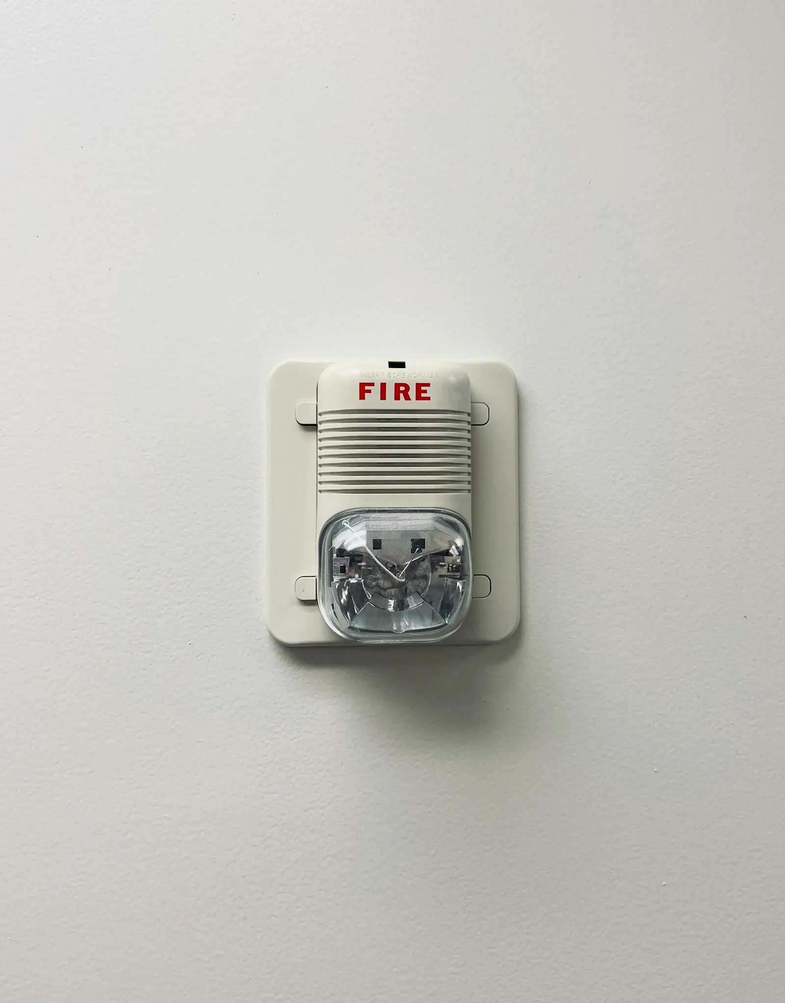 A fire alarm on a white wall