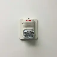 A smoke alarm being checked